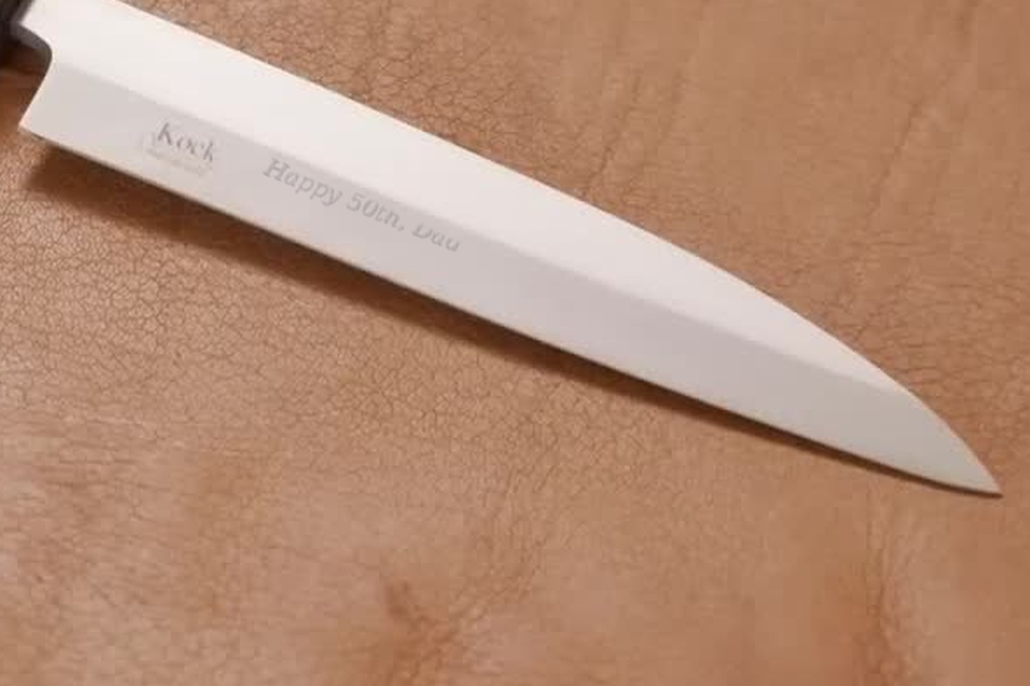 A custom knife engraved by hand: Happy 50th, Dad